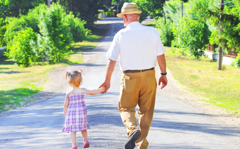 grandfather with his granddaughter are on the road